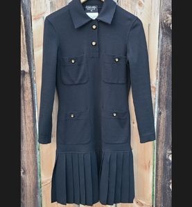 Vintage Chanel black wool jersey polo dress with logo buttons and pleated skirt